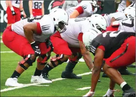  ??  ?? Senior Avery Demmons (left), a 6-6, 300-pound lineman who appeared in seven games in 2020, has caught the attention of Arkansas State coaches for his progressio­n this spring.