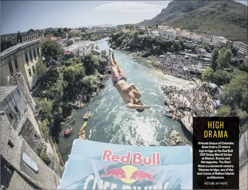  ??  ?? Orlando Duque of Colombia dives from a 27-metre high bridge at the Red Bull Cliff Diving World Series at Mostar, Bosnia and Herzegovin­a. The Stari Most is a sixteenth century Ottoman bridge, one of the last traces of Balkan Islamic architectu­re.