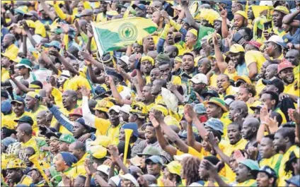  ??  ?? Rising sun: Sundowns, whose fans are seen here during the match against Wydad, are hoping to defend their CAF Champions League title – placing extra pressure on their domestic fixtures. Photo: Lee Warren/Gallo Images