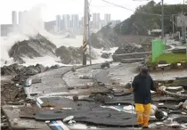  ?? YONHAP NEWS AGENCY PHOTO VIA AP ?? WRATHFUL WEATHER
A road is damaged as waves hit a shore in the city of Ulsan, southeaste­rn South Korea on Tuesday, Sept. 6, 2022.