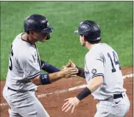  ?? Rob Carr / Getty Images ?? The Yankees’ Gleyber Torres, left, celebrates with Tyler Wade after they both scored in the ninth inning at Baltimore on Wednesday.