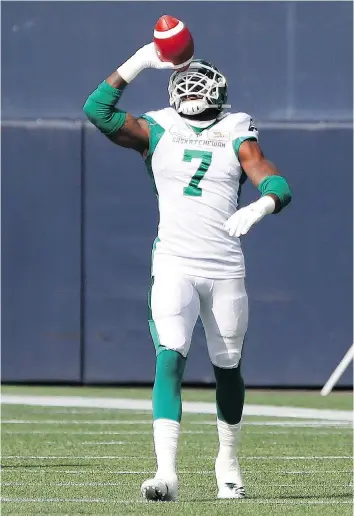  ?? JOHN WOODS/THE CANADIAN PRESS ?? Roughrider­s defensive end Willie Jefferson celebrates his 97-yard intercepti­on return for a touchdown during Saturday’s win over the host Winnipeg Blue Bombers.