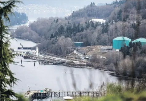  ?? CARMINE MARINELLI ?? The Kinder Morgan facility is seen in the Burrard Inlet in Burnaby, B.C. After a decade of trying to appease environmen­tal groups, the gloves are coming off in the battle over the controvers­ial Trans Mountain pipeline extension, Claudia Cattaneo writes.