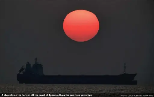  ?? PHOTO: OWEN HUMPHREYS/PA WIRE ?? A ship sits on the horizon off the coast at Tynemouth as the sun rises yesterday