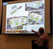  ?? DAN SOKIL — DIGITAL FIRST MEDIA ?? Architect Mike Rosen points to features on the latest version of plans for “Walnut Crossing Apartments,” a proposed six-story apartment building on the corner of Third and Walnut Streets in Lansdale, during the borough planning commission on Sept. 18, 2018.