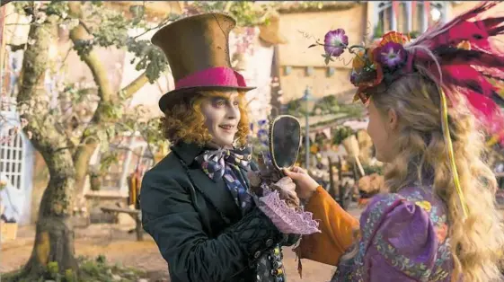  ??  ?? Johnny Depp and Mia Wasikowska both get lost in the dizzying computer generated imagery in “Alice Through the Looking Glass.”