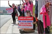  ?? Katharine Lotze/The Signal ?? Demonstrat­ors gather in front of Representa­tive Steve Knight’s Santa Clarita offices on Tuesday to voice their concerns over the Graham-Cassidy bill that would repeal the Affordable Care Act.