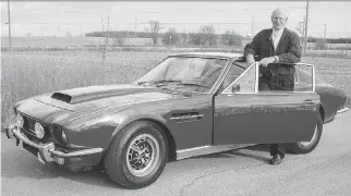  ?? CLAYTON SEAMS/ DRIVING ?? Peter Schurmann stands next to his 1974 Aston Martin V8.