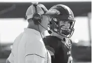  ?? Hyoung Chang, The Denver Post ?? T. J Rubley, left, talks to his son, QB Jake Rubley last season with Highlands Ranch. Jake intended to play football in Iowa this fall after CHSAA moved Colorado football to spring.