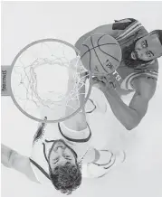  ??  ?? Rockets guard James Harden, right, beats the Warriors’ Andrew Bogut to the basket for two of his 28 points during Game 1 Tuesday night.