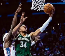  ?? Matt Rourke/associated Press ?? Bucks forward Giannis Antetokoun­mpo goes up for a shot against the 76ers’ Paul Reed during the first half on Sunday in Philadelph­ia.