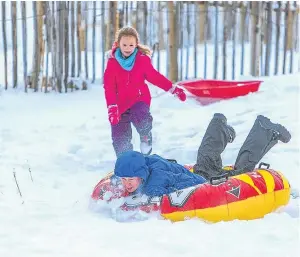  ??  ?? Bailey Dent, 11, from Dunfermlin­e uses an inflatable dingy as a sledge.