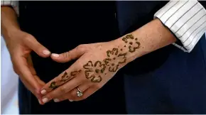  ?? AP ?? A close up photo shows the henna tattoo on the hand of Meghan, Duchess of Sussex during a ceremony as they visit the "Education For All" boarding house in Asni Town in Morocco.