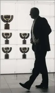  ?? Dean Bicknell, Calgary Herald ?? Brent Sutter walks by trophy case with all of the world hockey championsh­ip trophies Canada has won over the years in the Hockey Canada Hall of Champions.