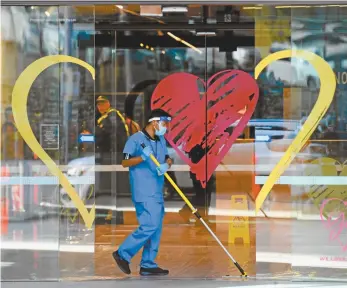  ?? AAP Image / James Ross ?? A cleaner works at the Novotel Melbourne South Wharf hotel, where people who have tested positive to Covid-19 are in quarantine.