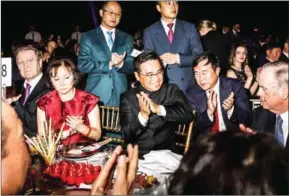  ?? KRISTA SCHLUETER/THE NEW YORK TIMES ?? Wang Jian (centre), co-founder of the HNA Group, one of China’s biggest conglomera­tes, at a ceremony in New York, February 22.