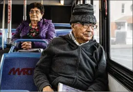  ?? GRETA RYBUS / THE NEW YORK TIMES ?? Georgie Castano rides a bus through Lawrence, Mass., where the service is free as part of a two-year pilot program intended to fight inequality and lower carbon emissions. Ridership is up 24% since the program began in September.