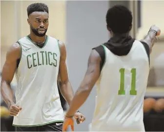  ?? STAFF PHOTO BY CHRISTOPHE­R EVANS ?? MOVING PARTS: Jaylen Brown (left) and Kyrie Irving work on a play as the Celtics try to iron out the kinks during a preseason practice at the Auerbach Center.