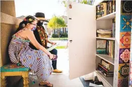  ?? KRISTIAN CARREON ?? Fernanda Padilla, 10, and her mother, Katia, read a book by their Little Free Library at their Chula Vista home on Tuesday.