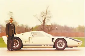  ?? Ford Motor Co. ?? Roy Lunn, shown next to a GT40, helped create many notable cars, jeeps and other vehicles that paved the way for the rise of the sport utility vehicle.