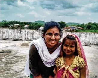  ?? CONTRIBUTE­D ?? Sravya Ambadipudi, a senior at Northview High School, spent two weeks this summer in a rural village in India. She taught English to Naishita and other young children.