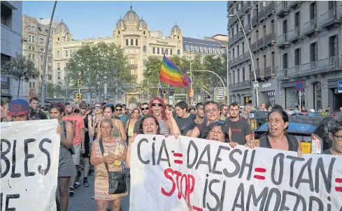  ??  ?? TAKING A STAND: Demonstrat­ors shout at members of a right-wing group that tried to protest against Islam on Las Ramblas in Barcelona, where a van killed at least 14 pedestrian­s.