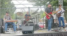  ?? Westside Eagle Observer/SUSAN HOLLAND ?? Johnny Dale Roberts and his band entertaine­d the Gravette Day crowd in Kindley Park for over an hour Saturday afternoon. Roberts, of Pineville, Mo., is pictured here with steel guitar player Eddie Snow, drummer Doug Fuller and bass player Joe Twist.