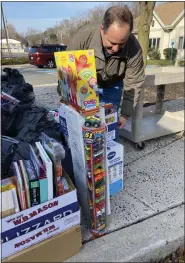  ?? ?? Zuber Realty agent Brian Gilbert adds to the collection of toys donated by the Boyertown and Royersford communitie­s for Toys for Tots. The toys were delivered to the Salvation Army of Boyertown for the Angel Tree program.