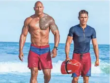  ?? FRANK MASI, SMPSP ?? Dwayne Johnson and Zac Efron are hard-bodied lifesavers and part-time superheroe­s in the comedy Baywatch.