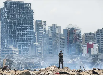  ?? THIBAULT CAMUS, POOL-ASSOCIATED PRESS ?? A soldier stands at the devastated site of the explosion in the port of Beirut, Lebanon, Thursday. French President Emmanuel Macron came in Beirut to offer French support to Lebanon after the deadly port blast.