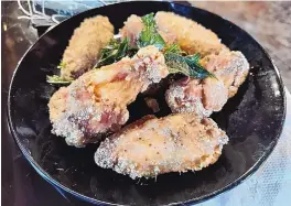  ?? ?? Battered and fried Chicken Wings, one of the appetizers at Zu Hot Pot.