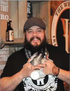  ??  ?? Brewmaster Joe Kearns displaying the medals won by The White Hag Brewery.