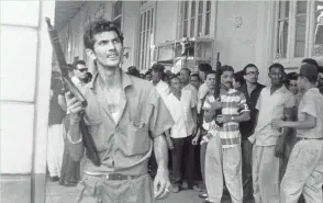  ?? WISCONSIN HISTORICAL SOCIETY ?? This photo by Shorewood native Dickey Chapelle shows two of Fidel Castro’s armed soldiers at the end of the Cuban Revolution in 1959. For more photos, go to jsonline.com/greensheet.