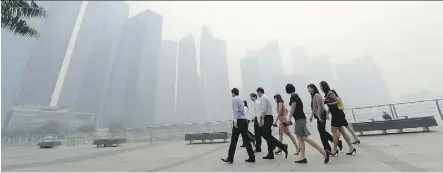  ?? ROSLAN RAHMAN/AFP/GETTY IMAGES/FILES ?? Polluted air, particular­ly fine particulat­e pollution, can even reach those who work inside, affecting performanc­e and therefore having an economic effect, a new study has found.