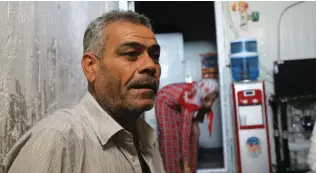  ?? (Sebastien Malo/Reuters) ?? SYRIAN REFUGEE Muhammad Said Amin, 48, sits in a former prison cell that as been converted into living quarters for refugees in the Akre refugee camp in Iraq.