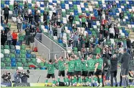  ??  ?? Glentoran show off the cup to their small band of fans