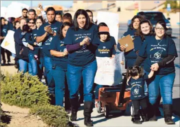  ?? Irfan Khan
Los Angeles Times ?? PARENTS DELIVER petitions to the principal of Desert Trails Elementary in Adelanto. “It felt really good to finally be speaking for our children and taking back our right to fight for them,” parent Doreen Diaz said.