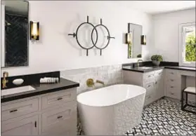  ??  ?? MODERN AND vintage touches mingle in one of the 3.25 bathrooms. The home has been updated, expanded and modernized.