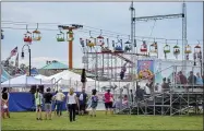  ??  ?? Visitors watch a performanc­e as part of the “Waterbark Show” on the midway at the NYS Fair.