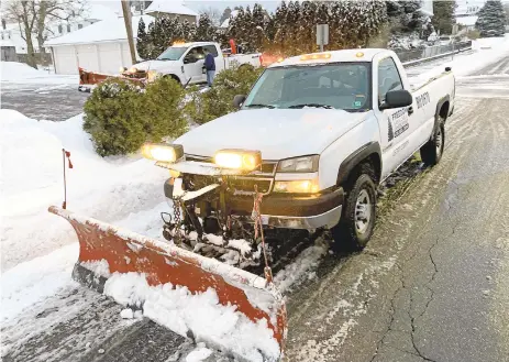  ?? MONICA CABRERA PHOTOS/THE MORNING CALL ?? Freedom Lawn Care & Landscapin­g, owned by brothers Mark and John Ingles, plows properties in Hellertown on Thursday night. They only service their full-time customers so that they can service them best in a manageable timeframe.