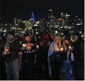  ?? THE ASSOCIATED PRESS ?? People attend a candleligh­t vigil for victims of a shooting at a Kansas City Chiefs Super Bowl victory rally last week in Kansas City, Mo.