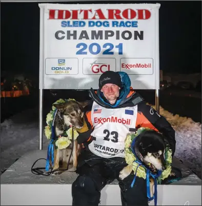  ?? Photo by The Iditarod/Dave Poyzer ?? 2021 IDITAROD CHAMPION— Not under the burled arch in Nome, but at Deshka Landing, Dallas Seavey and his lead dogs enjoy their 2021 Iditarod victory, in the early morning hours of Monday, March 15.