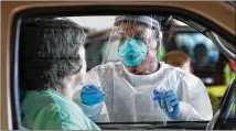  ?? CURTIS COMPTON / CCOMPTON@AJC.COM ?? Emory Hospital RN Aisha Bennett takes a nasal swab at a large-scale drive-thru COVID-19 testing site in the Georgia Internatio­nal Horse Park in April. It still sometimes takes days for people to get their results.