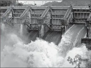  ?? AP/RICARDO ARDUENGO ?? through an open bay at the Carraizo Dam after a storm dumped heavy rain in Trujillo Alto, Puerto Rico, on Saturday.