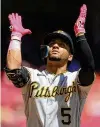  ?? ?? Pittsburgh Pirates’ Michael Perez celebrates hitting a tworun home run off Reds starting pitcher Tyler Mahle to give the Pirates an early lead.