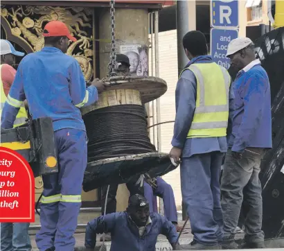  ?? Picture: Nigel Sibanda ?? POWER TO THE PEOPLE. City Power workers in Johannesbu­rg CBD yesterday, after thieves gained access to undergroun­d tunnels housing electricit­y cables, stealing some and burning others.