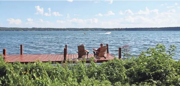  ?? CHELSEY LEWIS / MILWAUKEE JOURNAL SENTINEL ?? Green Lake is a popular vacation spot in the summer. At 236 feet deep, Green Lake is Wisconsin’s deepest natural inland lake.