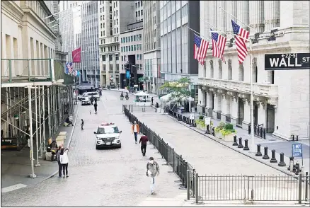  ??  ?? A police car patrols in front of the New York Stock Exchange, Oct 7. Stocks opened broadly higher on Wall Street Wednesday after President Donald Trump said he could be willing to sign off on specific aid measures for airlines and small businesses as well as another round of relief checks. (AP)