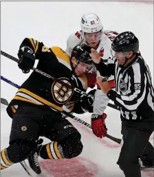  ?? STUART CAHILL / HERALD STAFF FILE ?? SPARK NEEDED: Linesman Jonny Murray attempts to escape the mayhem of a faceoff between Erik Haula and Carolina’s Jesperi Kotkaniemi in Game 3.