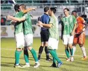  ??  ?? The Energy’s Wojciech Wojcik, second from left, hugs Danni Konig as the Energy celebrates a goal by Wojcik.